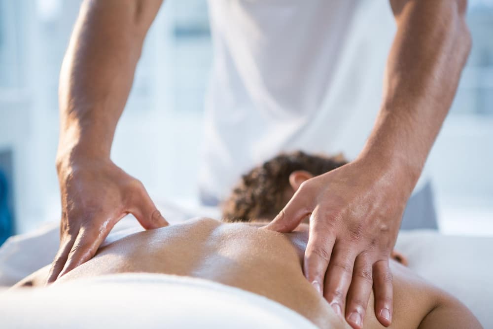 A person lying on his back to get massage