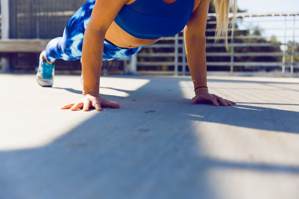 A woman in a blue sports wear doing planking